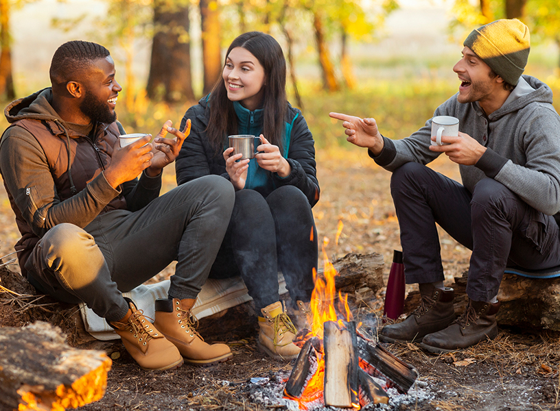 Friends sitting by a campfire